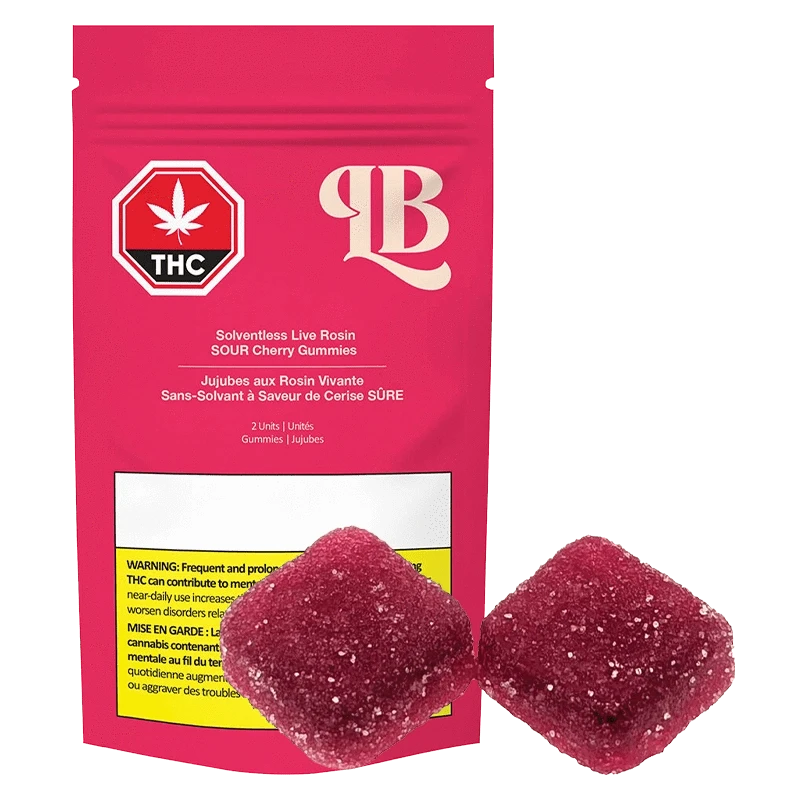 Close-up of red Live Rosin Sour Cherry Gummies against a black background, highlighting their translucent, textured surface.