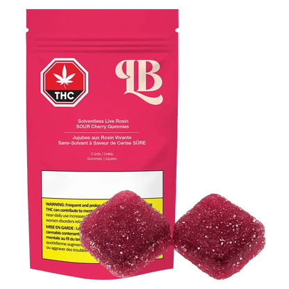 Close-up of red Live Rosin Sour Cherry Gummies against a black background, highlighting their translucent, textured surface.