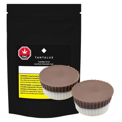 A close-up of the Forbidden Fruit Live Rosin Chocolate Cup against a black background, showing the product packaging.
