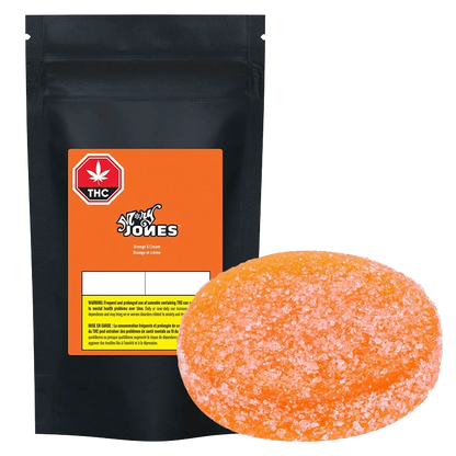 Close-up of the packaged Orange & Cream Gummies by STØNER, showing the branded design with a THC warning label.