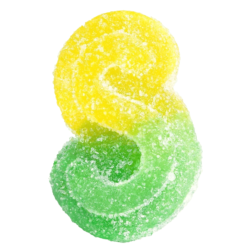 A close-up overhead view of Fully Blasted Mango Lime 1:1 CBC:THC Gummies, showing vibrant yellow and green hues.