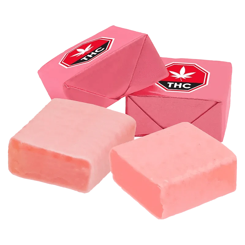 A close-up overhead view of the 3:1 Original Strawberry Taffy CBG/THC Gummies, showing a stack of colorful, square candies.