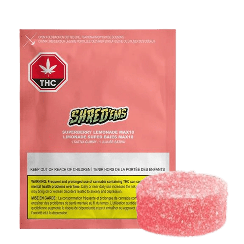 Straight-on shot of a pink pouch and a sugar-coated gummy labeled Superberry Lemonade Max10 Gummies, the pouch showing the SHRED'EMS logo and THC warning.