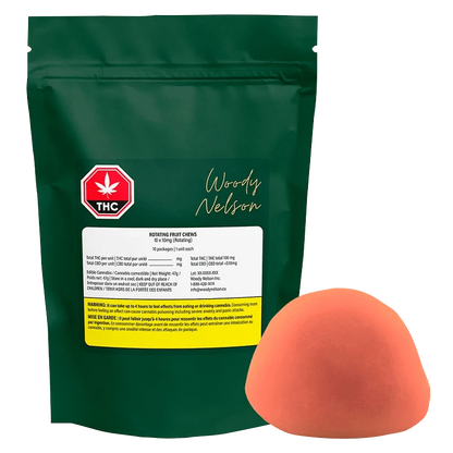 Front view of a green pouch labeled Woody Nelson Rotating Fruit Chews Gummies with a red THC symbol and a single orange half-sphere candy beside it