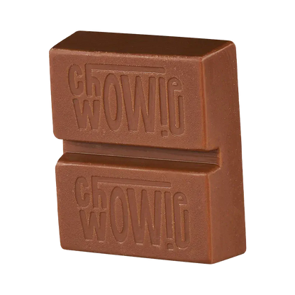 Close-up three-quarter view of a stacked chocolate piece embossed with the Balanced Milk Chocolate name, shown against a white background.