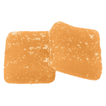 Top-down close-up of two sugar-coated orange squares of Sour Peach Mango 3:1 CBG:THC Gummies.
