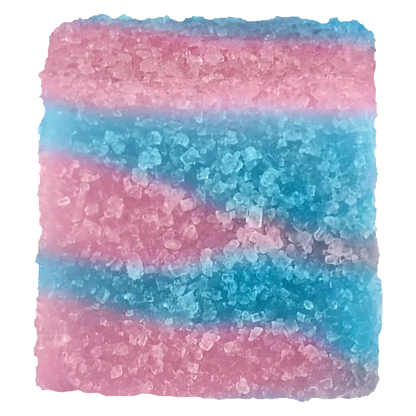 Close-up top view of a pink-and-blue sugar-coated cube of True Hybrid Rosin Blue Raspberry Cotton Clouds Gummies showing granular texture and layered swirls.