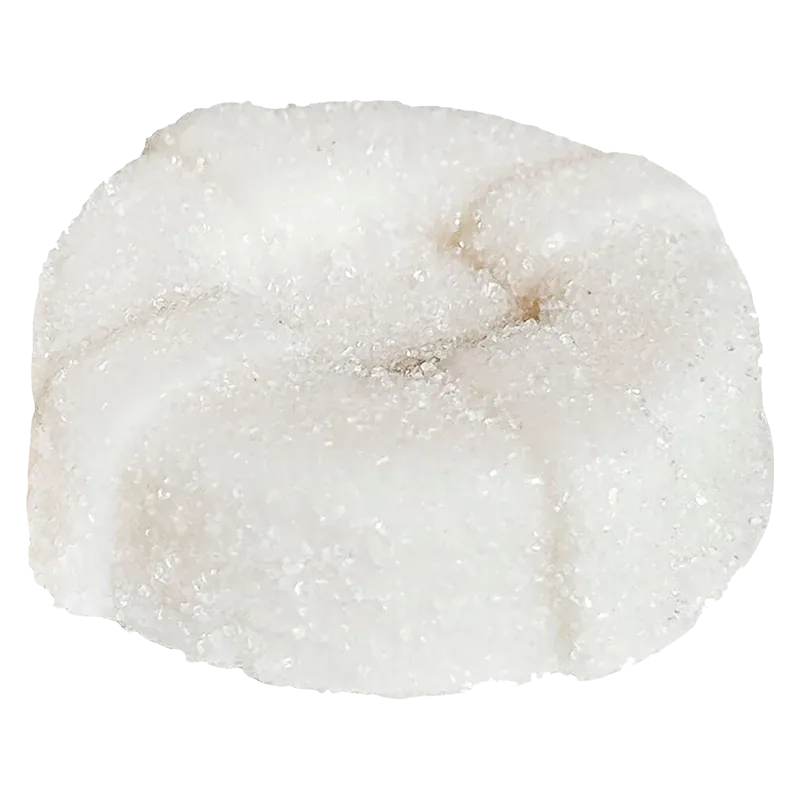 Close-up of a sugar-coated white gummy, a round flower-shaped piece labeled The Mystery White One THC Gummies.