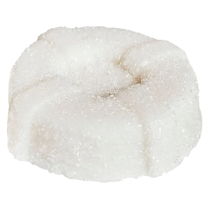 Close-up of a sugar-coated white gummy, a round flower-shaped piece labeled The Mystery White One THC Gummies.