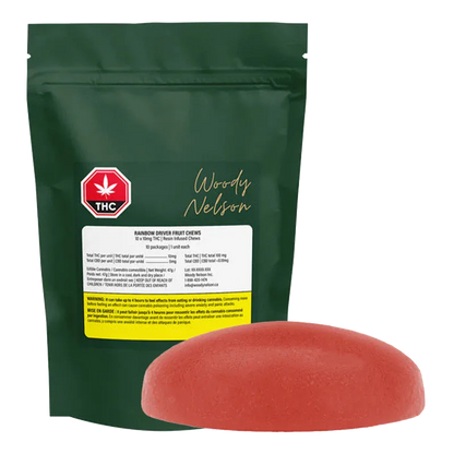 Front view of a green pouch and a single red gummy, showing the Rainbow Driver Cured Resin Fruit Gummies pouch standing upright with its label and a rounded red chew in front.