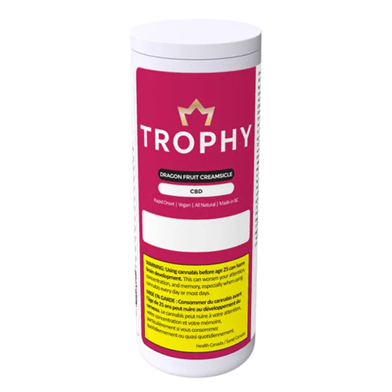 Front-facing shot of a white canister labeled "TROPHY Dragon Fruit Creamsicle Gummies" with a magenta label, gold crown logo, and safety text.