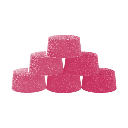 Stacked pyramid of six bright pink Dragon Fruit Creamsicle Gummies coated in sugar against a white background.