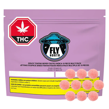 Front-facing view of a purple pouch labeled "Space Tokens Berry - Tastic! Gummies" with a central Fly North UFO logo, a red THC stop sign, and ten pink sugar‑coated gumdrops arranged at the pouch base