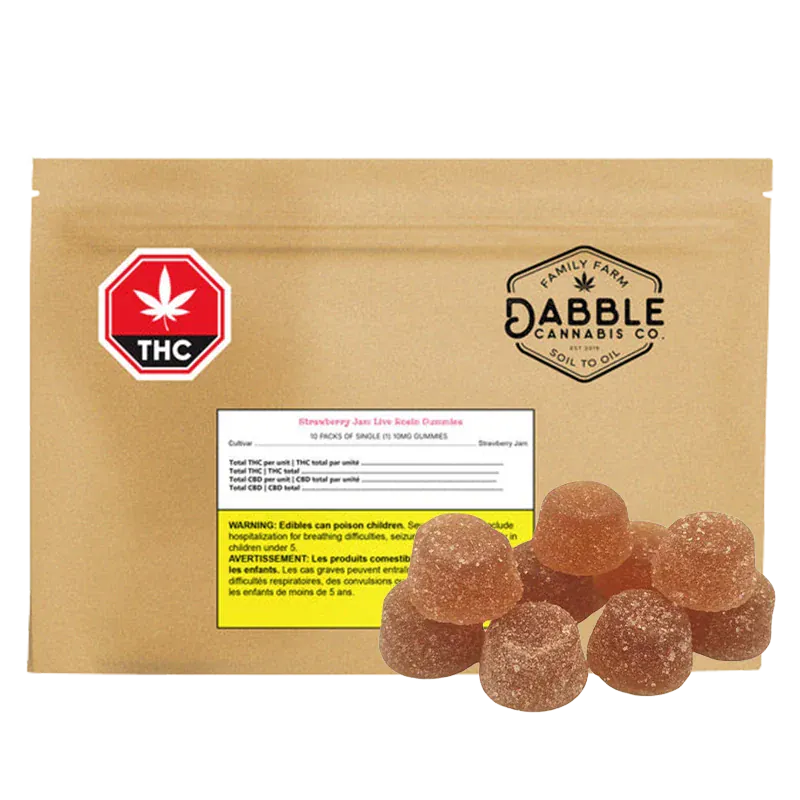 Rounded pile of sugar-coated gummies in front of a tan pouch labeled Dabble Cannabis Co. Strawberry Jam Live Rosin Gummies.