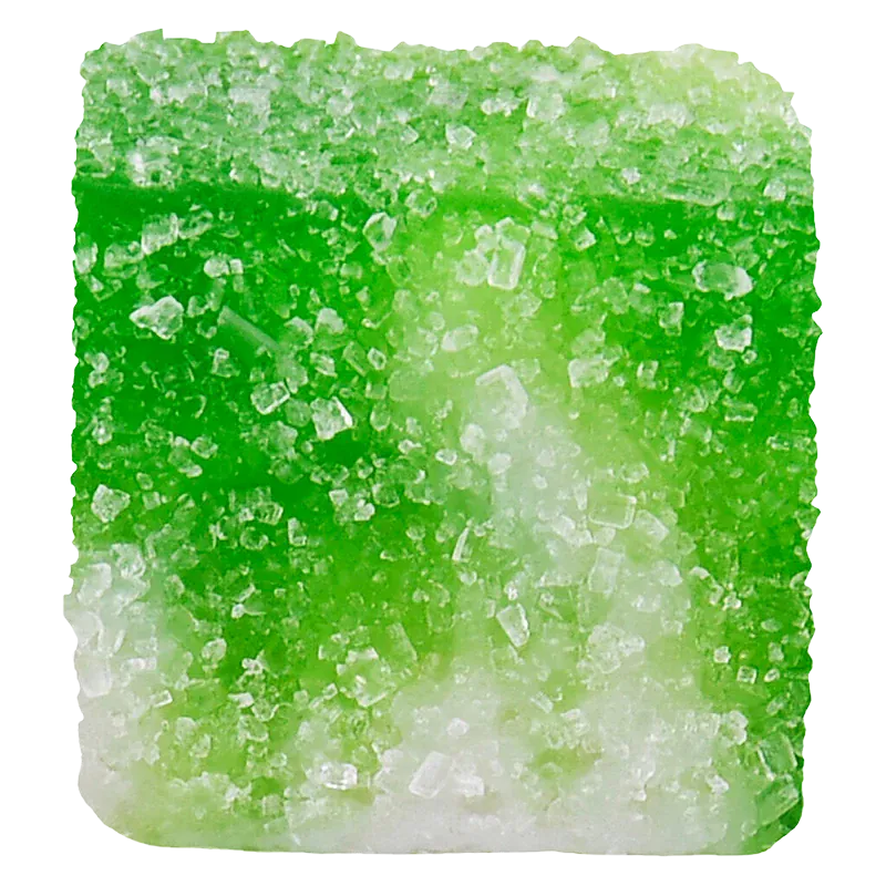 Close-up of a sugar-coated green gummy showing crystalline texture and square shape, labeled Green Apple Carton True Indica Resin Gummies
