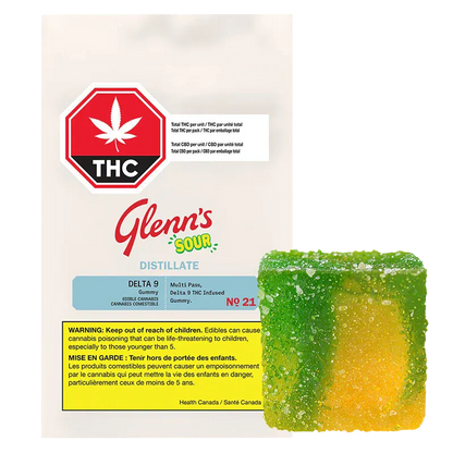 Packshot of the No.21 Distillate Delta 9 Sour Mango pouch with a green-and-yellow sugar-coated gummy placed to its lower right.