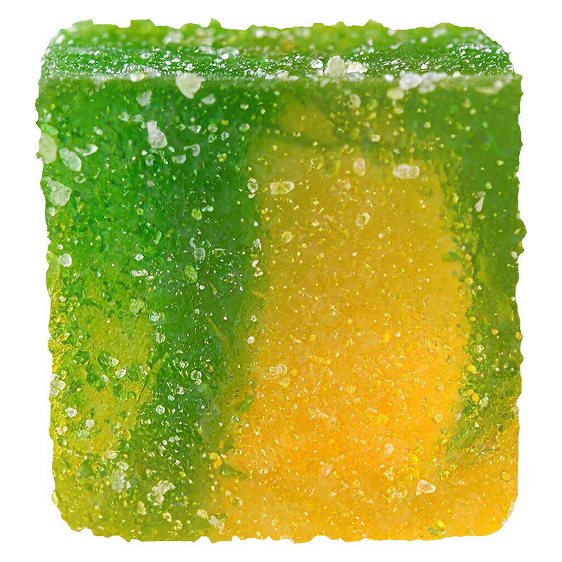 Close-up of a sugar-coated green and yellow gummy cube of No.21 Distillate Delta 9 Sour Mango.