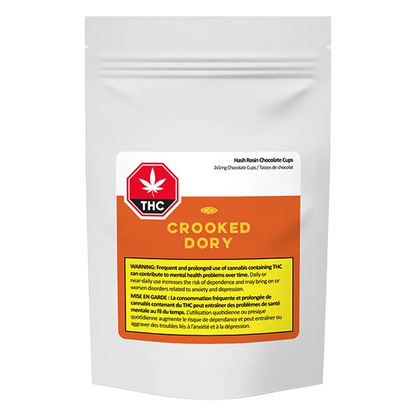 Front-facing shot of a white pouch labeled "Crooked Dory Hash Rosin Chocolate Cups" with an orange label, THC symbol, and a yellow warning panel.