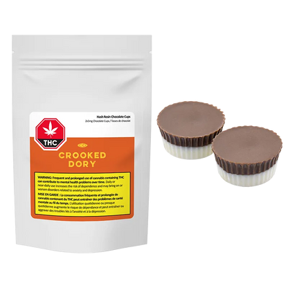 White resealable pouch labeled "Crooked Dory Hash Rosin Chocolate Cups" shown front-on beside two round chocolate cups on a white background
