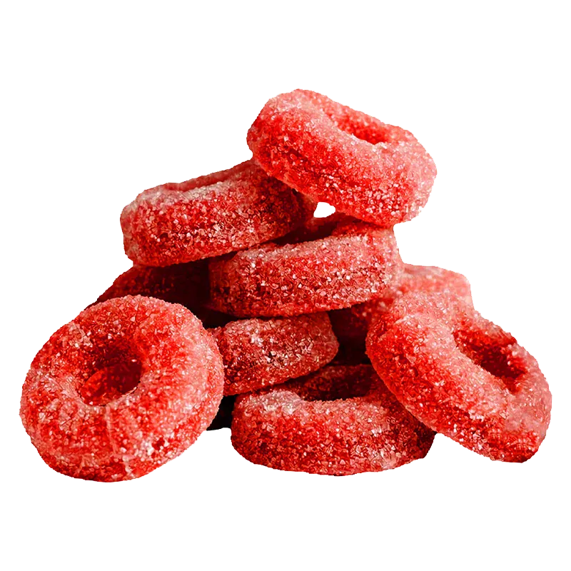 Close-up of a stacked pile of red sugar-coated ring gummies, labeled CBG Cluster Bomb The Red One Gummies.