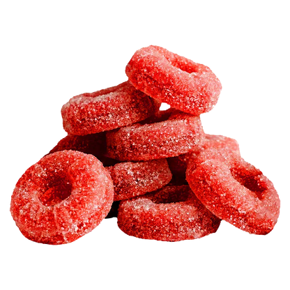 Close-up of a stacked pile of red sugar-coated ring gummies, labeled CBG Cluster Bomb The Red One Gummies.