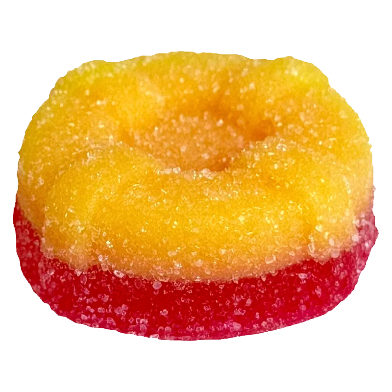 Close-up of a two-toned sugar-coated gummy in yellow over red, photographed from slightly above, showing texture and a shallow center, Ratio'd Tropic Boost Gummies