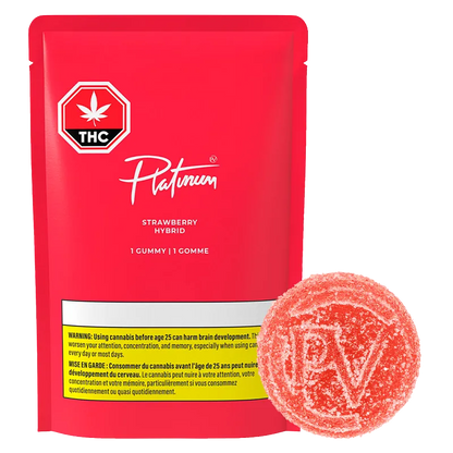 Front view of a red Platinum Strawberry Gummies pouch with white logo and a sugar-coated round strawberry gummy beside it.