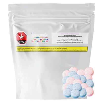 Front-facing shot of a white pouch with a small THC warning label and scattered pink and blue tablets, labeled "Full Spectrum Live Rosin Boosts Gummies."