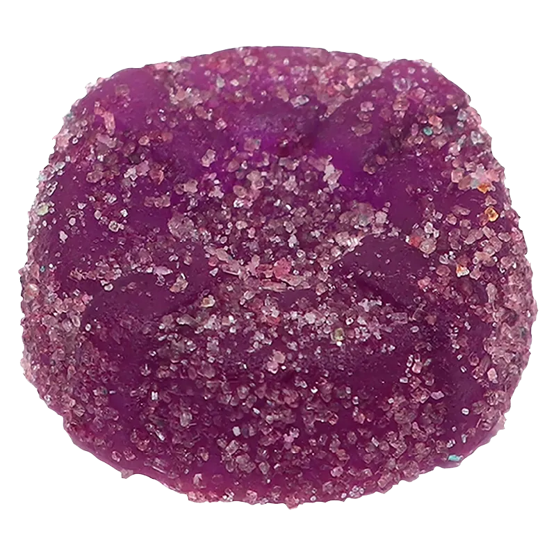 Close-up top view of a sugar-coated purple gummy, the Sour Purple One Live Rosin Indica Gummies shown against a white background.