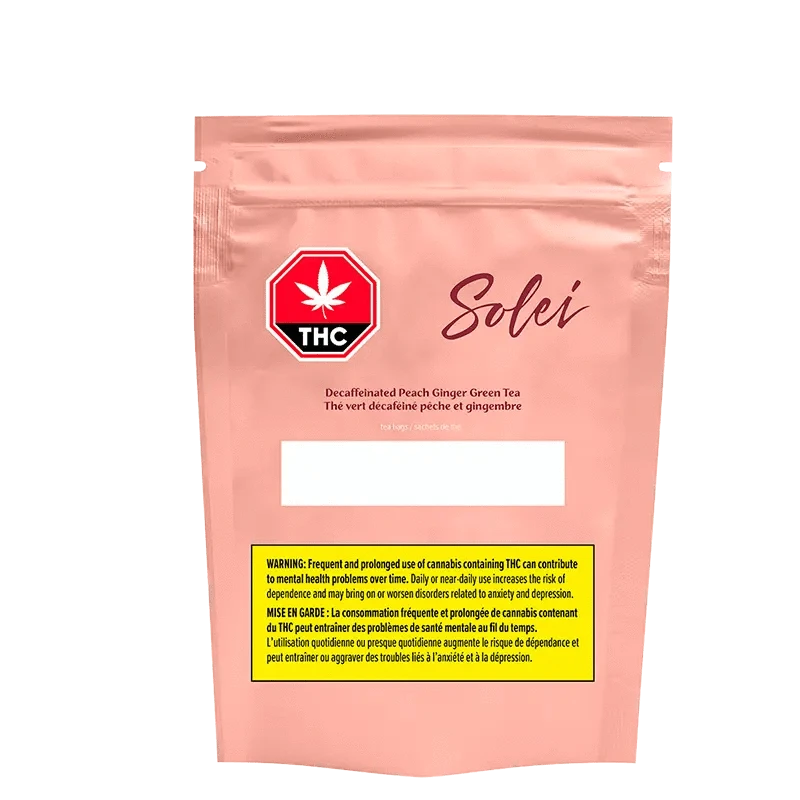 Front-facing shot of the pink Solei Decaffeinated Peach Ginger Green Tea Bags pouch with a THC stop-sign logo and yellow warning box.