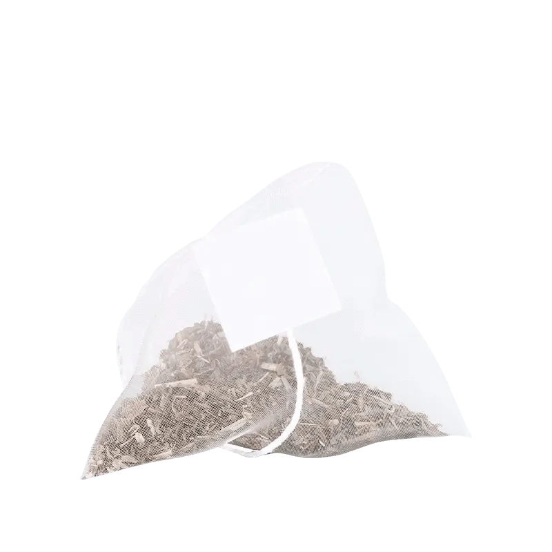Close-up of a single pyramid tea bag of Decaffeinated Peach Ginger Green Tea Bags filled with loose dried tea and a white tag against a plain white background