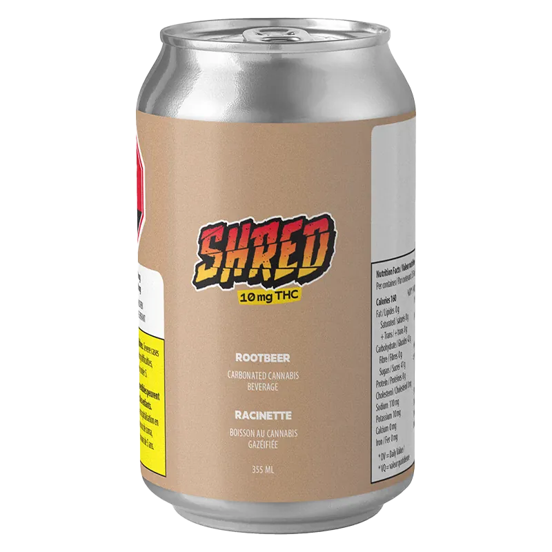 Angled front view of a Shred Rootbeer 6 Pack can with beige label, bold "SHRED" logo and nutrition panel visible on white background