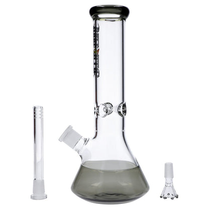 Front view of the Dopezilla New York Water Pipe - Transparent Black - 12in. showing a 12-inch beaker base with smoky black tint, two glass accessories beside it on a white background