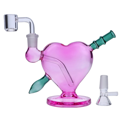 Angled side view of the Heart Bong w/Bowl + Banger showing a pink heart-shaped body with green mouthpiece and clear banger.