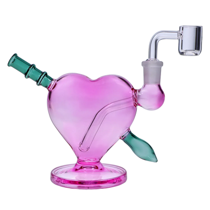 Angled close-up of the Heart Bong w/Bowl + Banger showing its pink heart-shaped body with teal mouthpiece and clear glass banger.