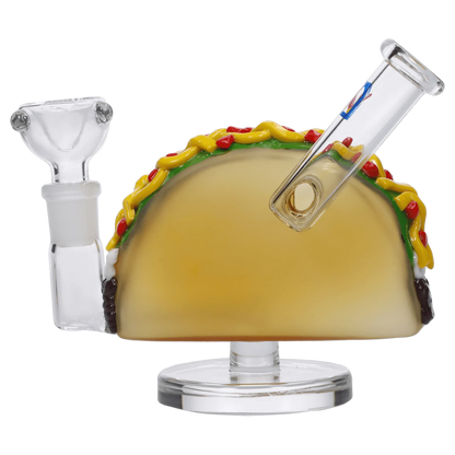 A studio shot displays the 4-inch DHC Originals Taco Dual-Use Water Pipe, shaped like a taco with a clear glass body.