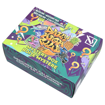 Angled top-down view of the colorful DHC - Mystery Box - Dank Desert showing graffiti-style art, a pineapple, question marks, and bold "Mystery Box" text.