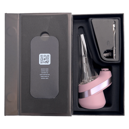 Top-down view of the boxed Puffco New Peak - Glückseligkeit in pink showing the angled glass mouthpiece, molded foam tray, and included metal tool.