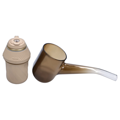 Side view of the tan Proxy – Desert showing the textured cylindrical base with "PUFFCO" branding and a translucent brown glass attachment.