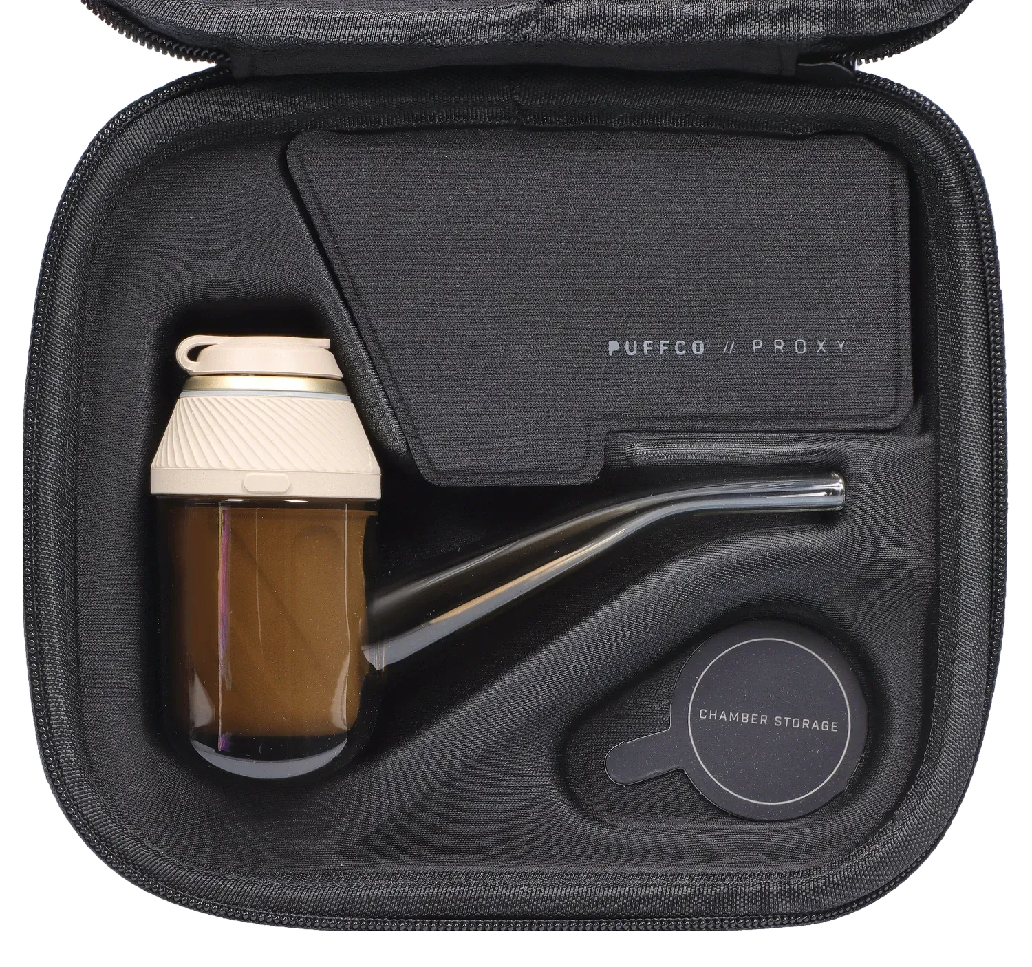 Top-down view of the PUFFCO – Proxy – Desert kit nestled in a black zippered case, showing the tan glass chamber, curved glass mouthpiece, and labeled accessories.
