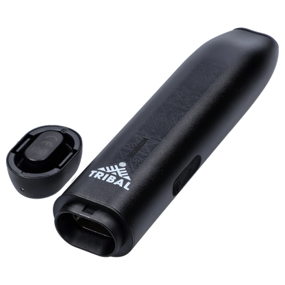 Angled close-up of the black Tribal Aerolith Dry Herb Vaporizer showing its embossed pattern, white TRIBAL logo, mouthpiece opening, and detached magnetic cap.