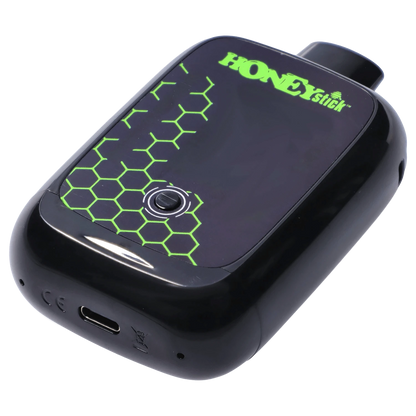 Angled close-up of the glossy black HoneyStick Duo Variable Voltage Plus showing its green honeycomb pattern and single round control button.