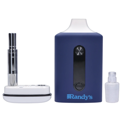 Close-up front view of the steel blue Randy's Inspo Dual 510 Battery- Steel Blue showing its rectangular body, black control strip with two circular buttons, and surrounding metal and glass accessories.