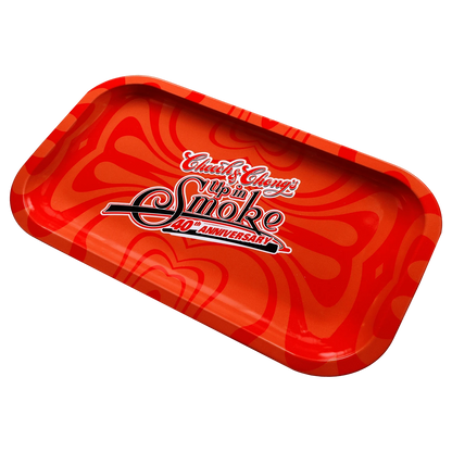 Angled top-down view of the red C&C 40. Jubiläum Rolling Tray - Rot - Mittel showing swirled orange patterns and a central "Up in Smoke 40th Anniversary" logo.