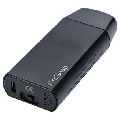 Angled close-up of the black Cipher ArcSnap Electronic Dugout showing its rounded edges, USB-C port, vent holes, and white ArcSnap logo.
