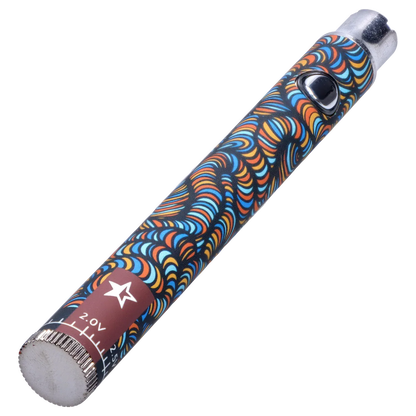 Diagonal close-up of the Famous Design Lit Sticc VV Battery - Mixed Design showing its colorful swirling orange, blue and yellow pattern, silver button and end caps