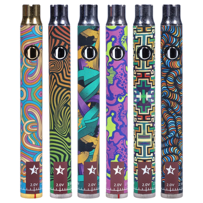 Front-facing close-up of six colorful Famous Design Lit Sticc VV Battery - Mixed Design pens standing upright, each showing a chrome button and distinct psychedelic pattern.