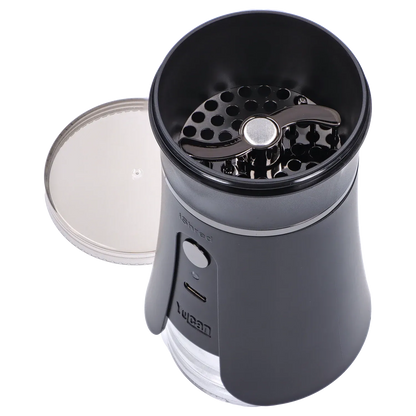 Top-down view of the open Yocan iShred Electronic Grinder – Black showing the circular perforated grinding plate and curved chrome rotor against a pale background