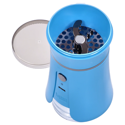 Top-down close-up of the open Yocan iShred Electronic Grinder – Blue showing its metallic dual blades and perforated grinding plate inside the bright blue housing