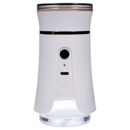 Front-facing close-up of the ivory Yocan iShred Electronic Grinder showing its cylindrical top, central button and USB-C port against a soft gray striped background